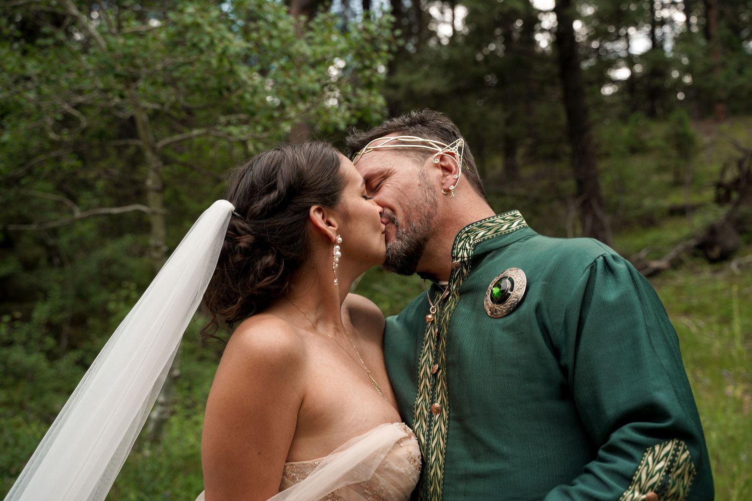 A romantic wedding kiss sequence showing seven progressive moments between a couple in a forest setting.