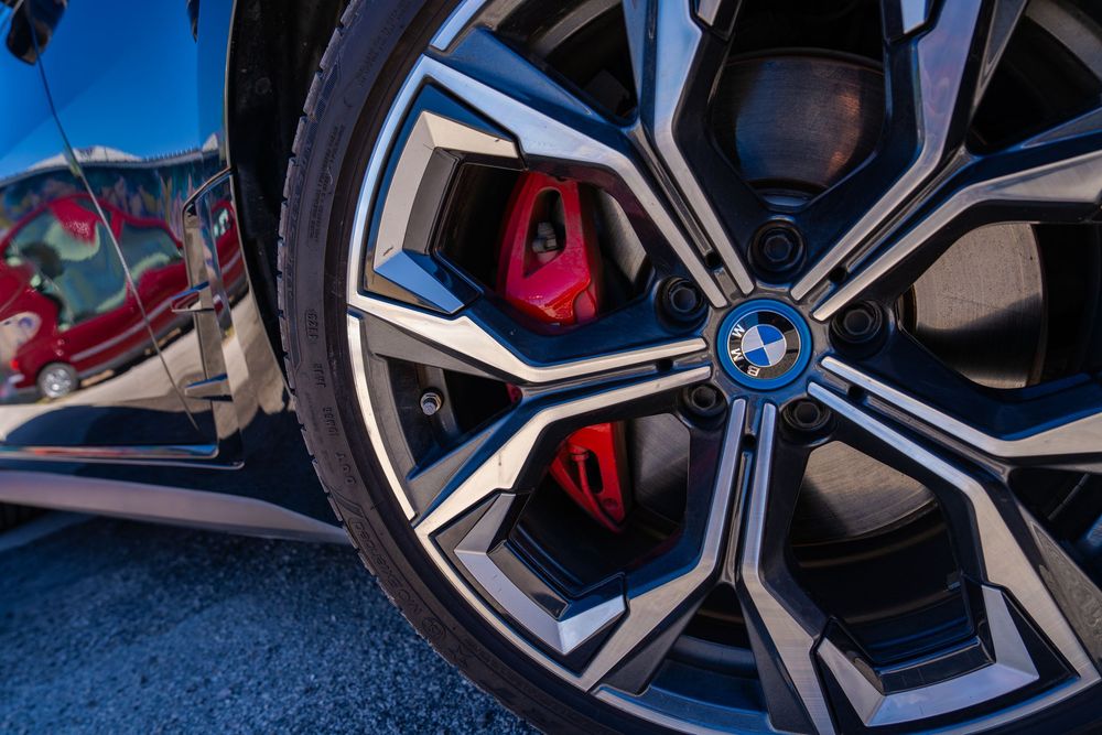 Close-up detail shots of a BMW 4 Series interior showing red leather seats and modern dashboard controls.