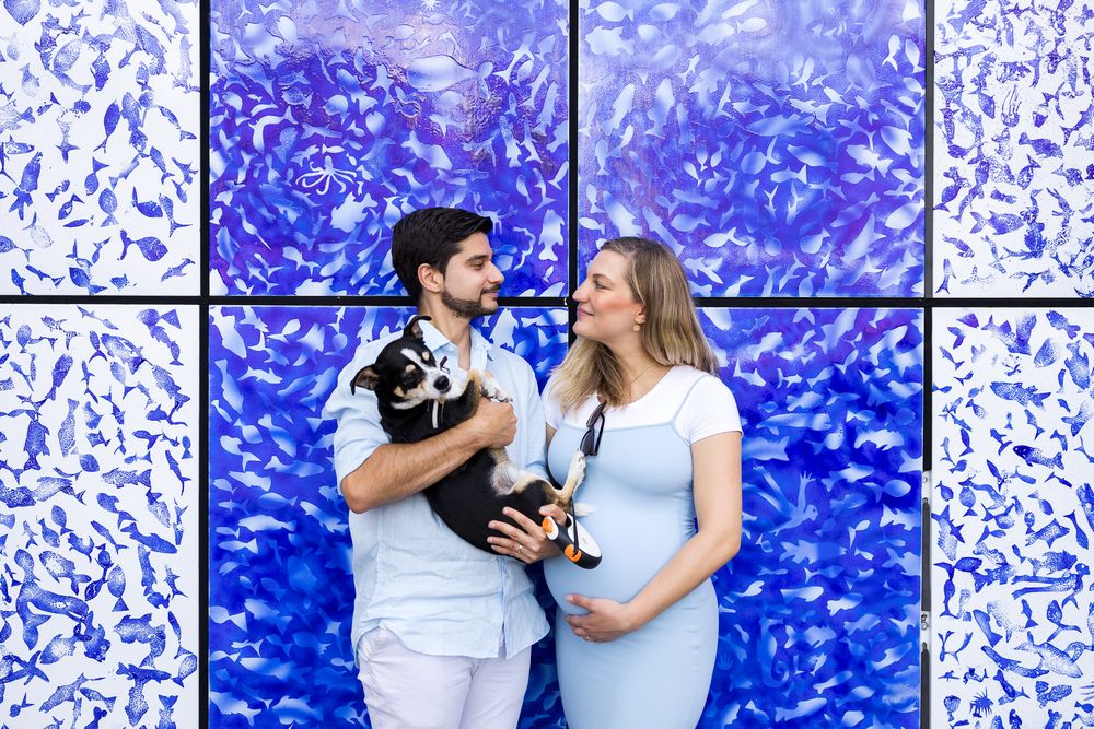 a couple standing in front of blue and white painted wall