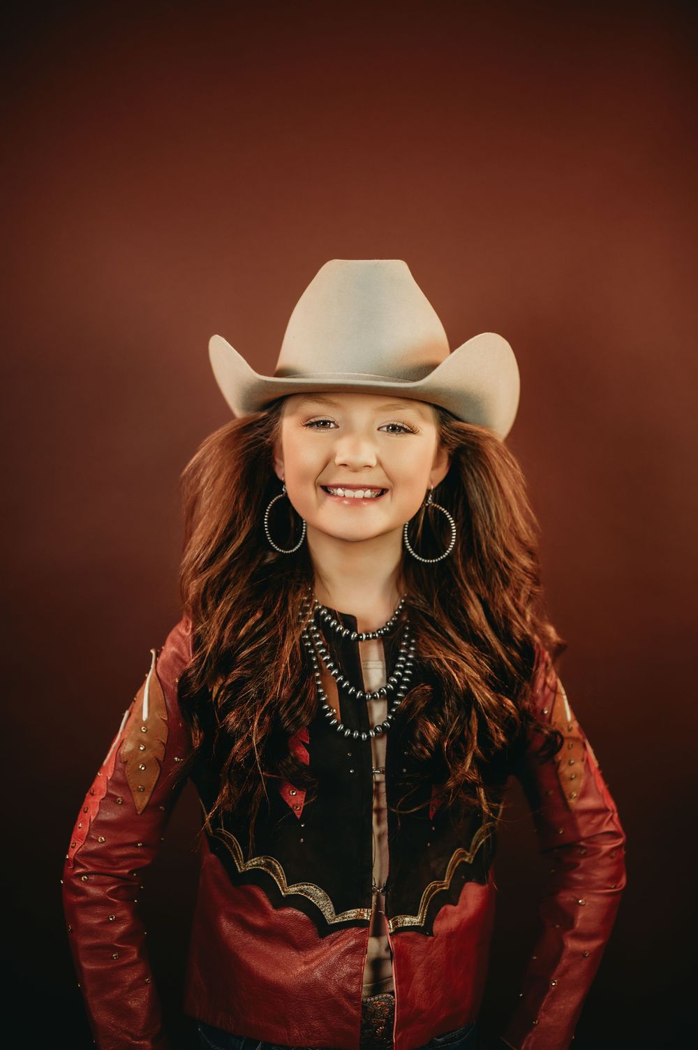 Country western portrait featuring red leather jacket and statement turquoise necklace.
