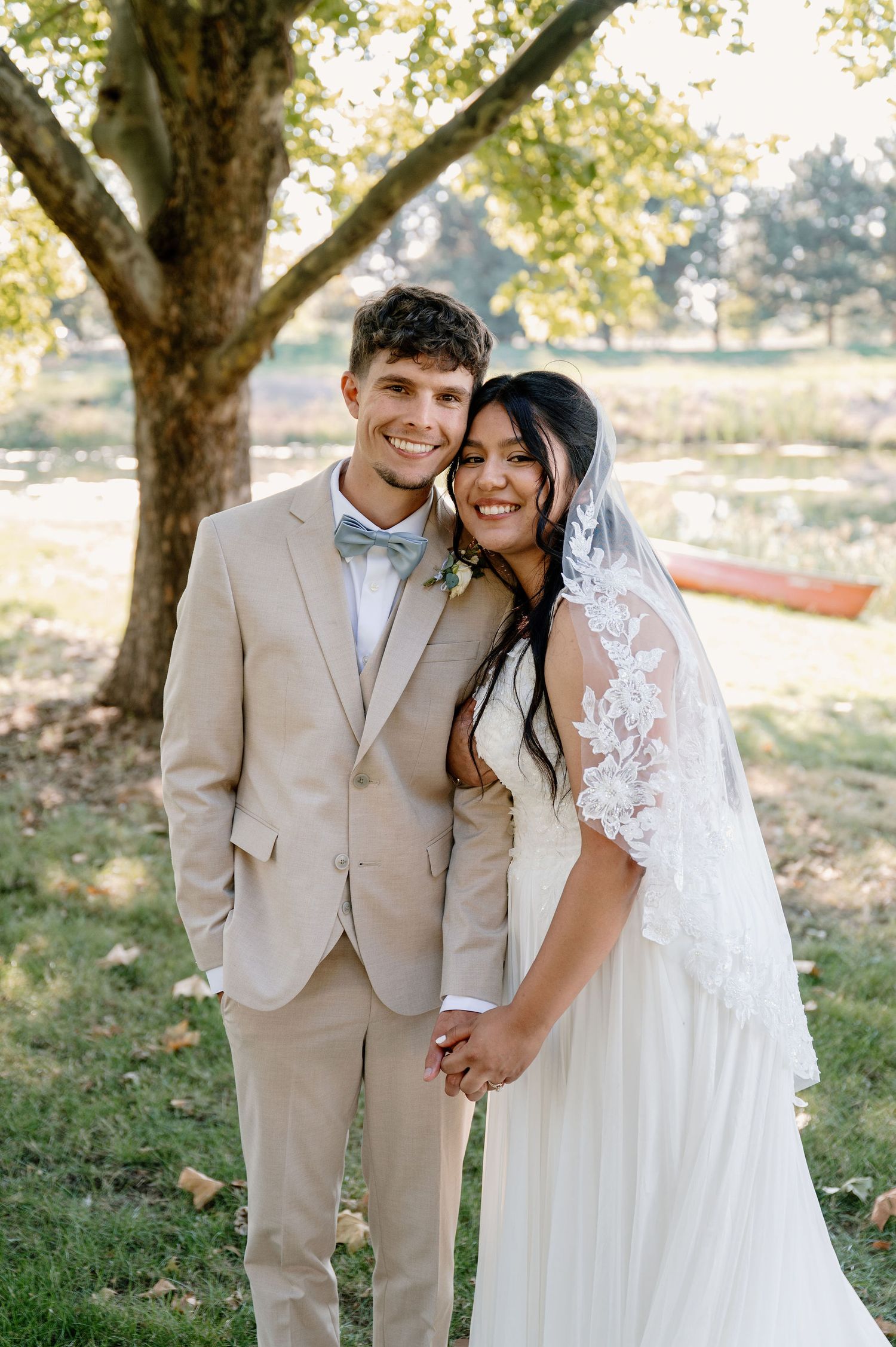 Bride and groom portraits by a pond for their outdoor wedding in Oregon