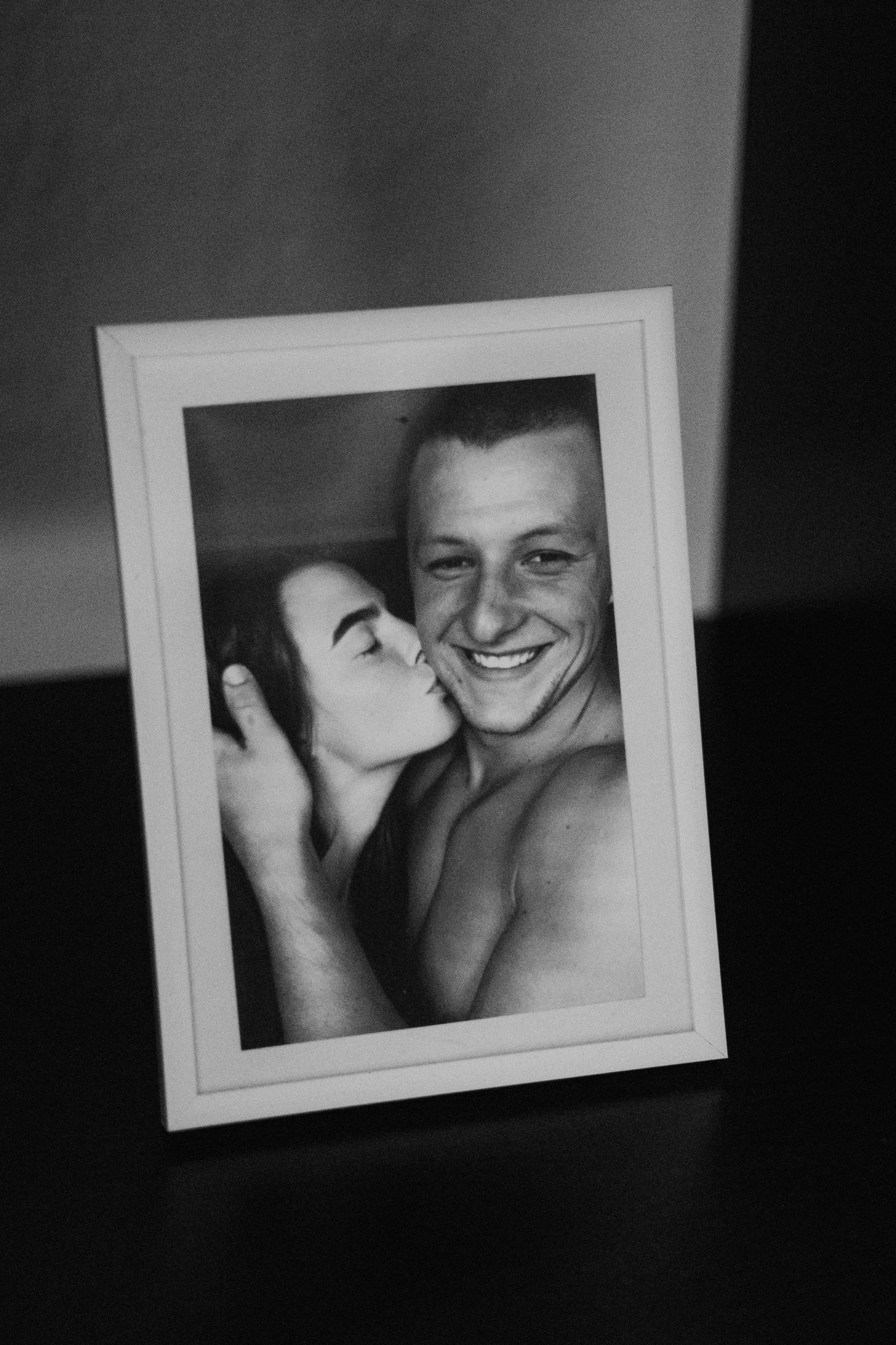 Series of black and white framed photos showing intimate couple moments.