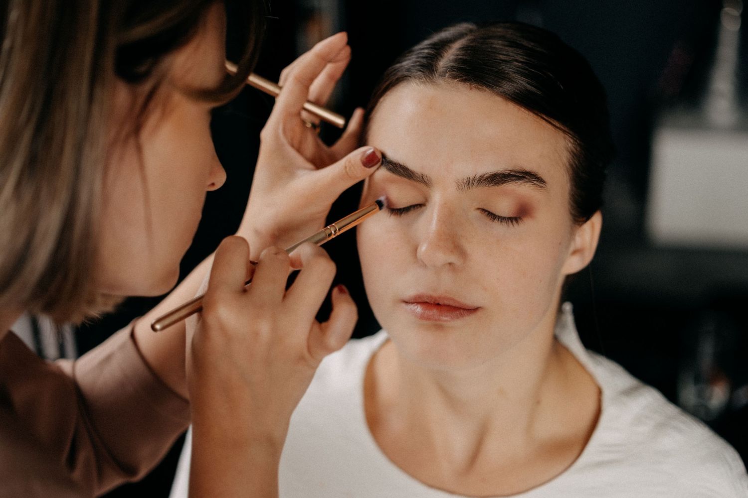Close-up shot of wedding day makeup application in natural light.
