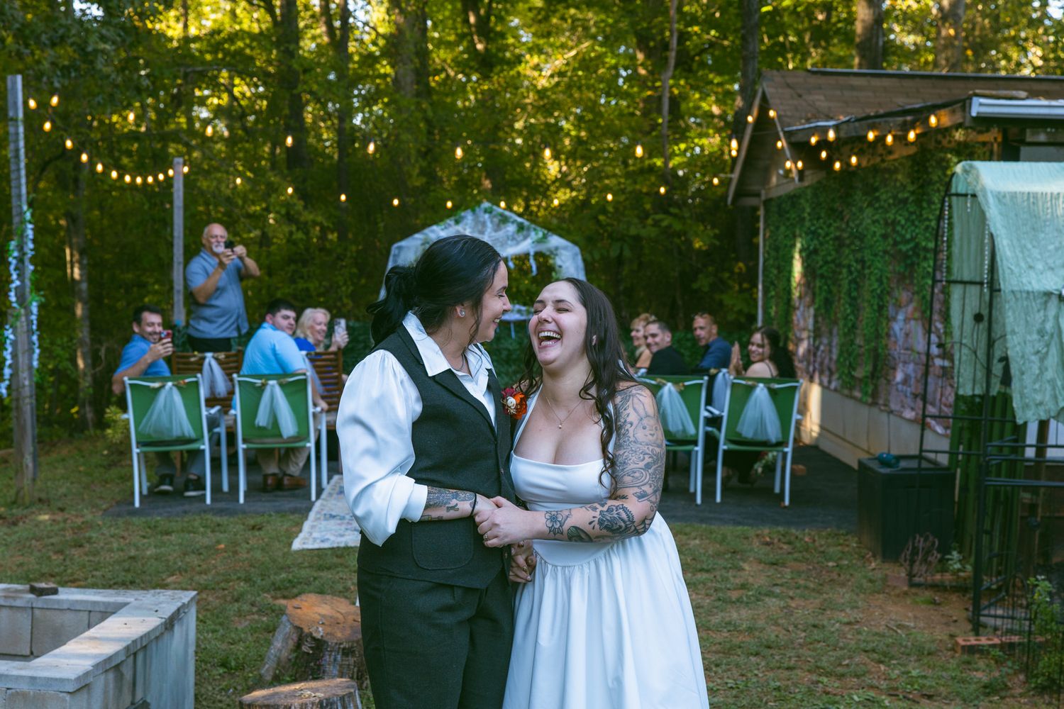 happy brides after walking down the aisle at backyard wedding ceremony in Asheville NC