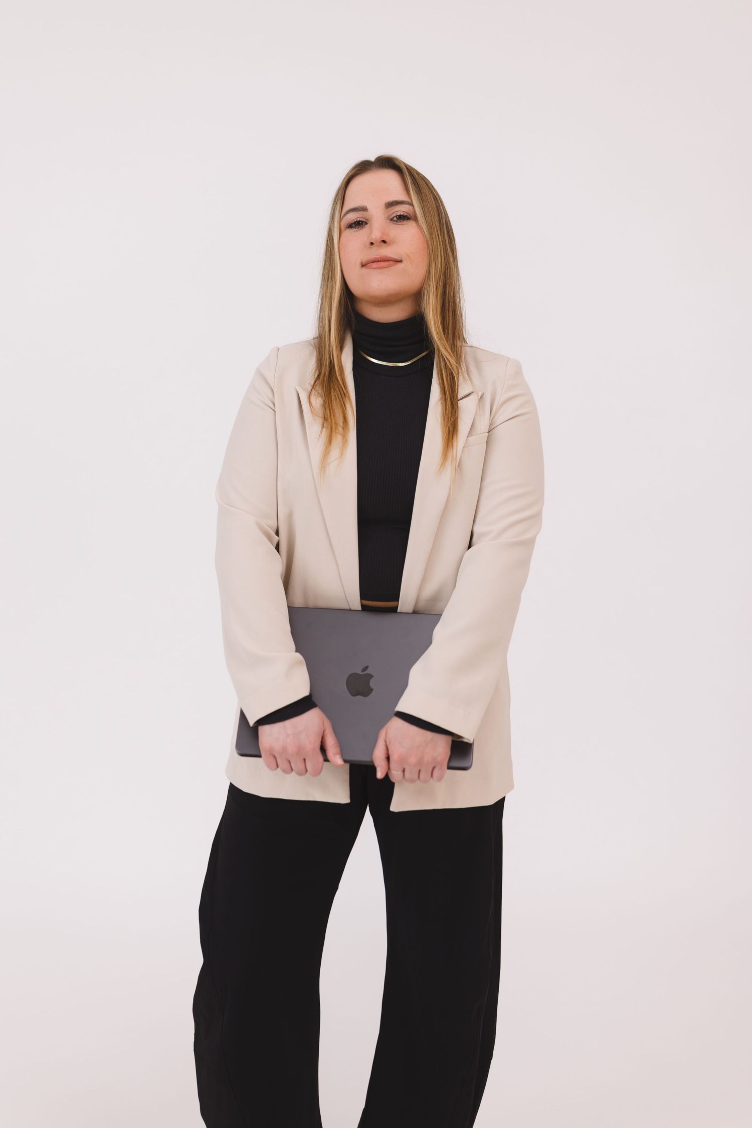 Person in black outfit holding a book while posing in three different positions against white background.