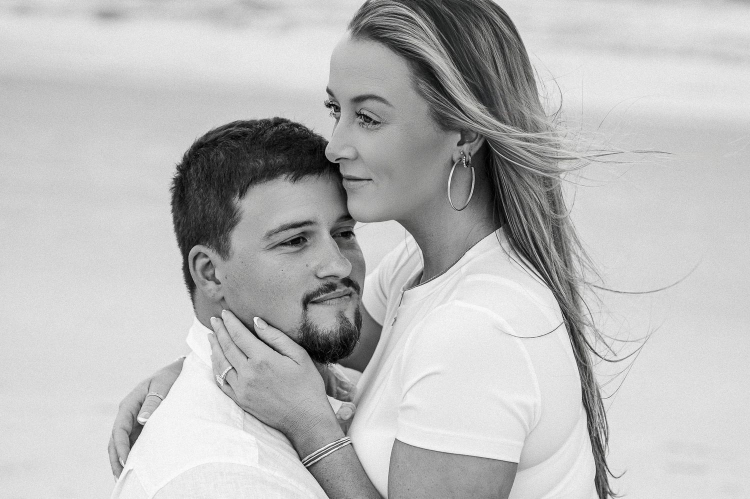 Black and white series of romantic beach portraits showing intimate couple moments.