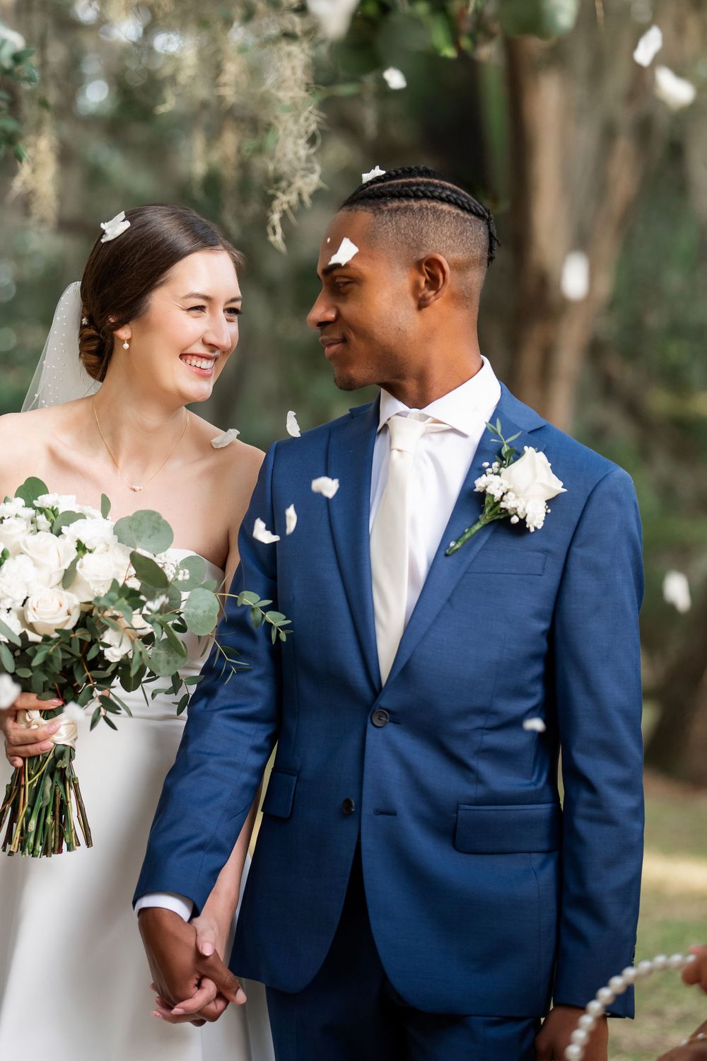 Bride and Groom under flower petals