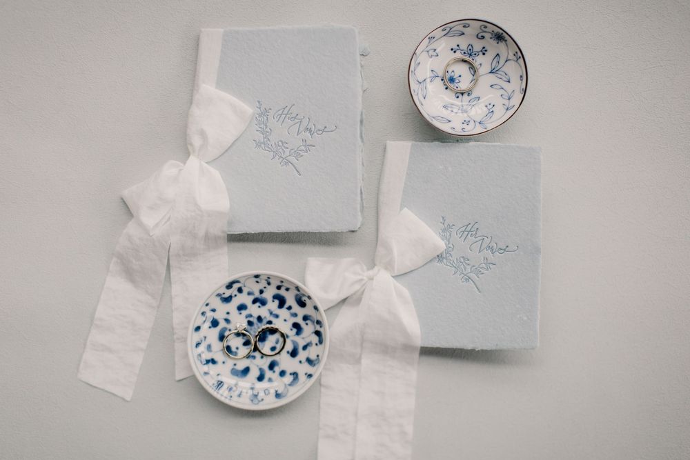 Delicate blue and white porcelain plates and packaging arranged in an elegant flat lay composition.