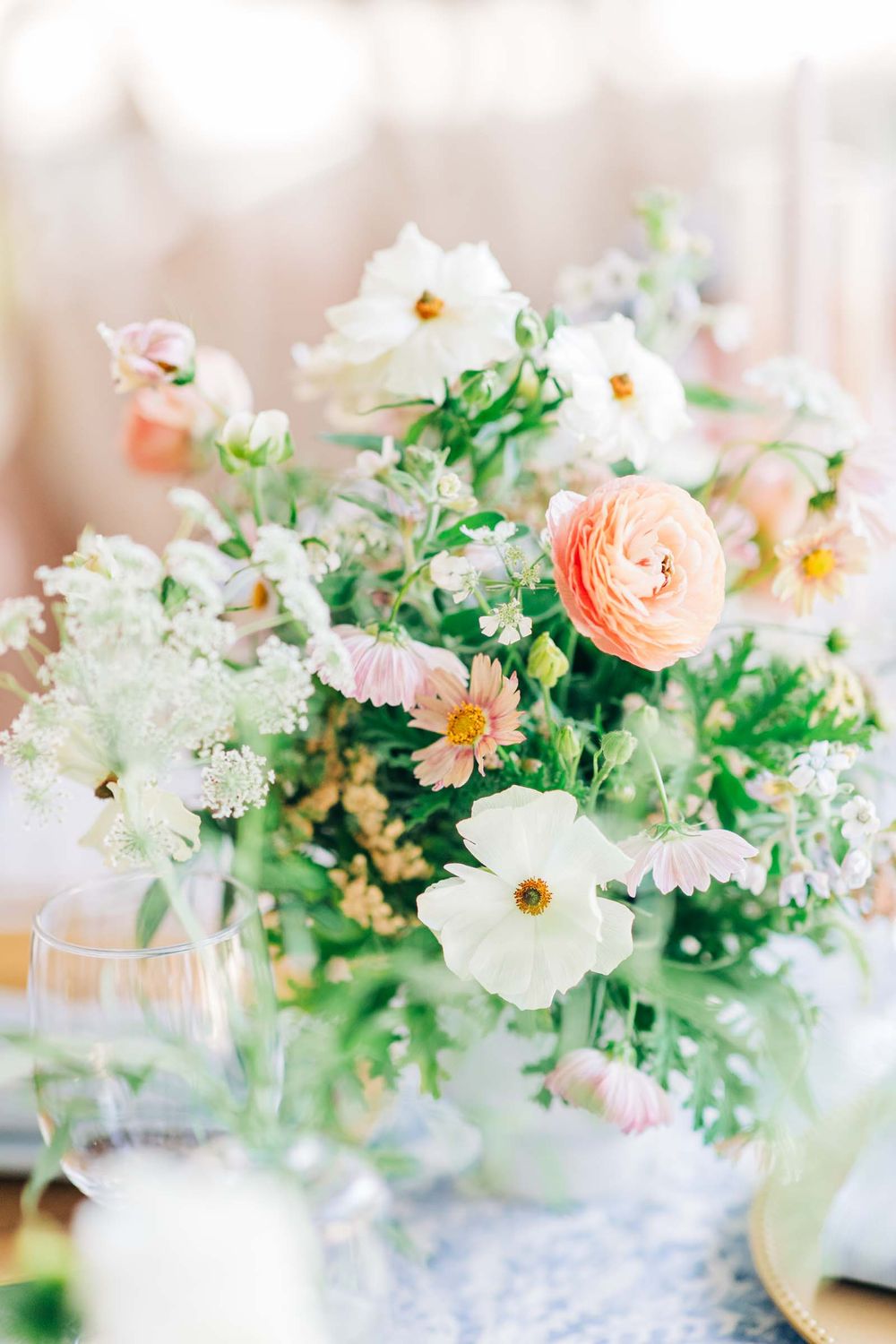 Delicate floral centerpiece with soft peach ranunculus, white flowers and fresh greenery at 255 Milledge, Hardeman - Sams Estate