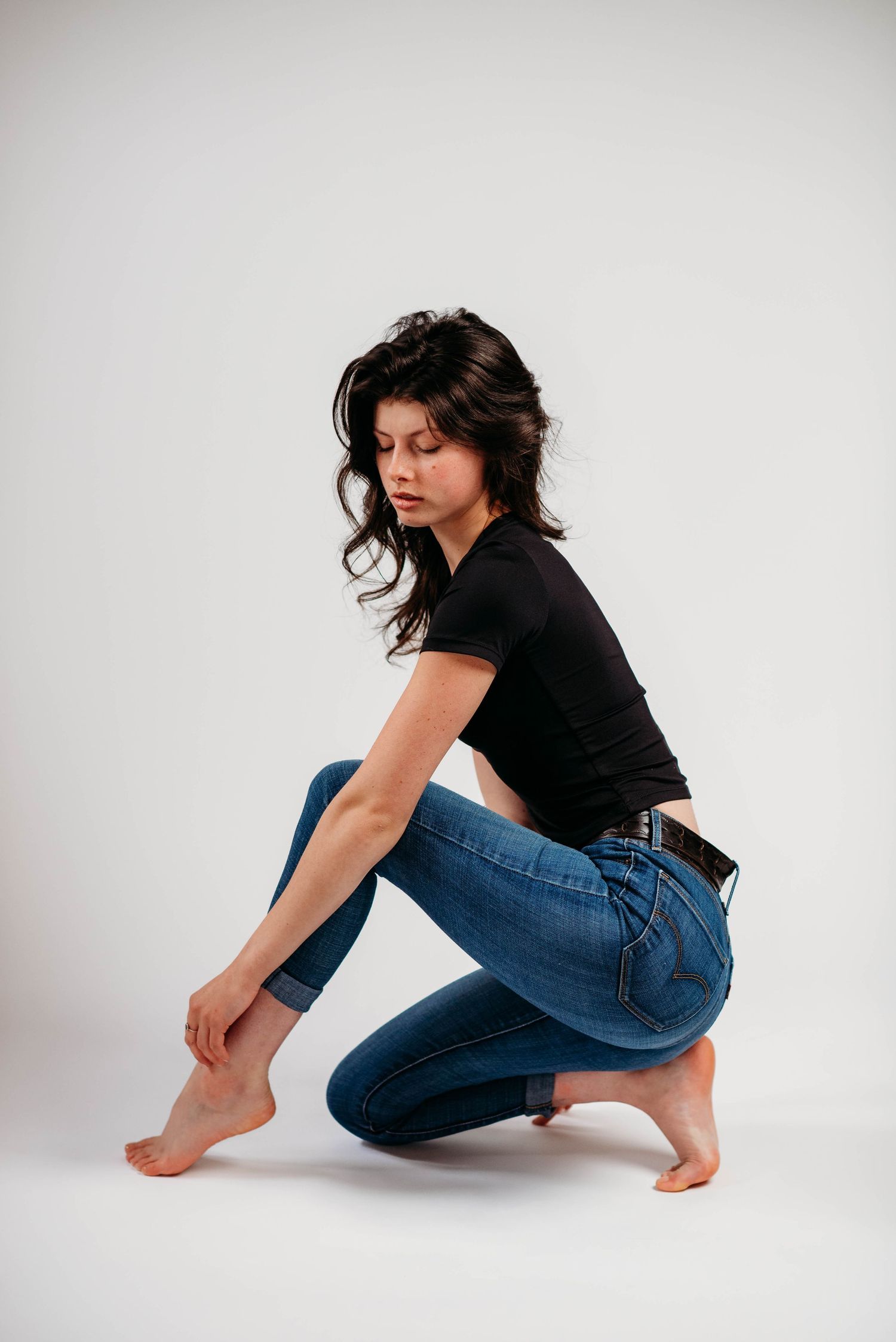 Self-love portrait session photographed on a white backdrop with studio flash lighting.
