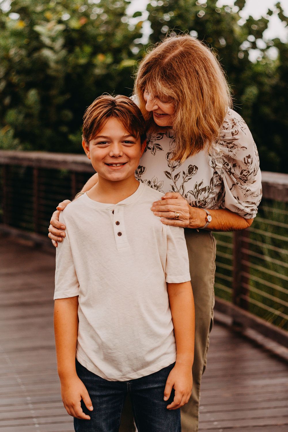 A sequence of candid shots showing a child in a white t-shirt and jeans on a wooden bridge outdoors.