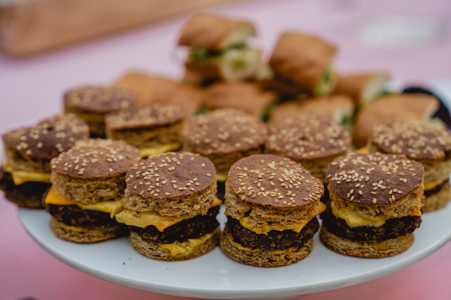 Mini burger sliders arranged on serving tray at birthday event