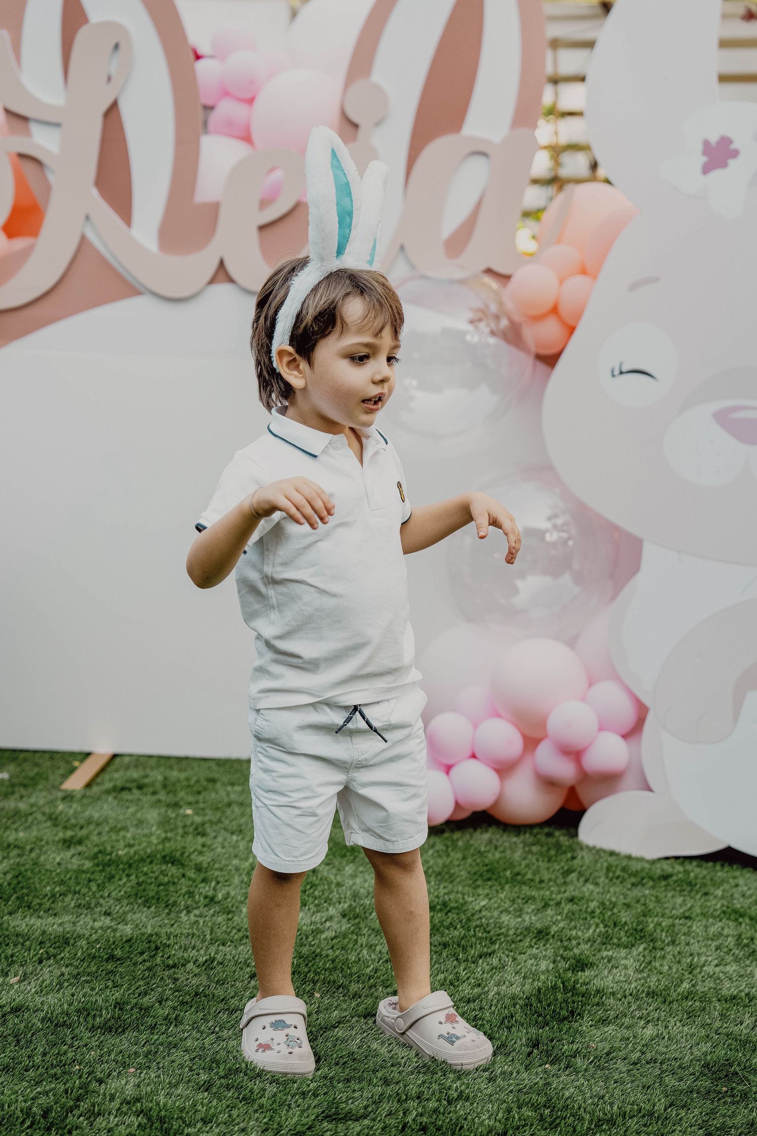 Young boy posing in front of balloon birthday setup in Dubai
