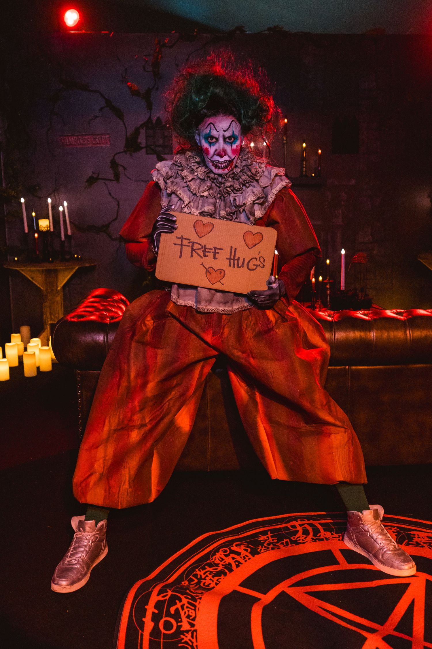 Halloween performer in dramatic costume holding themed prop at night event