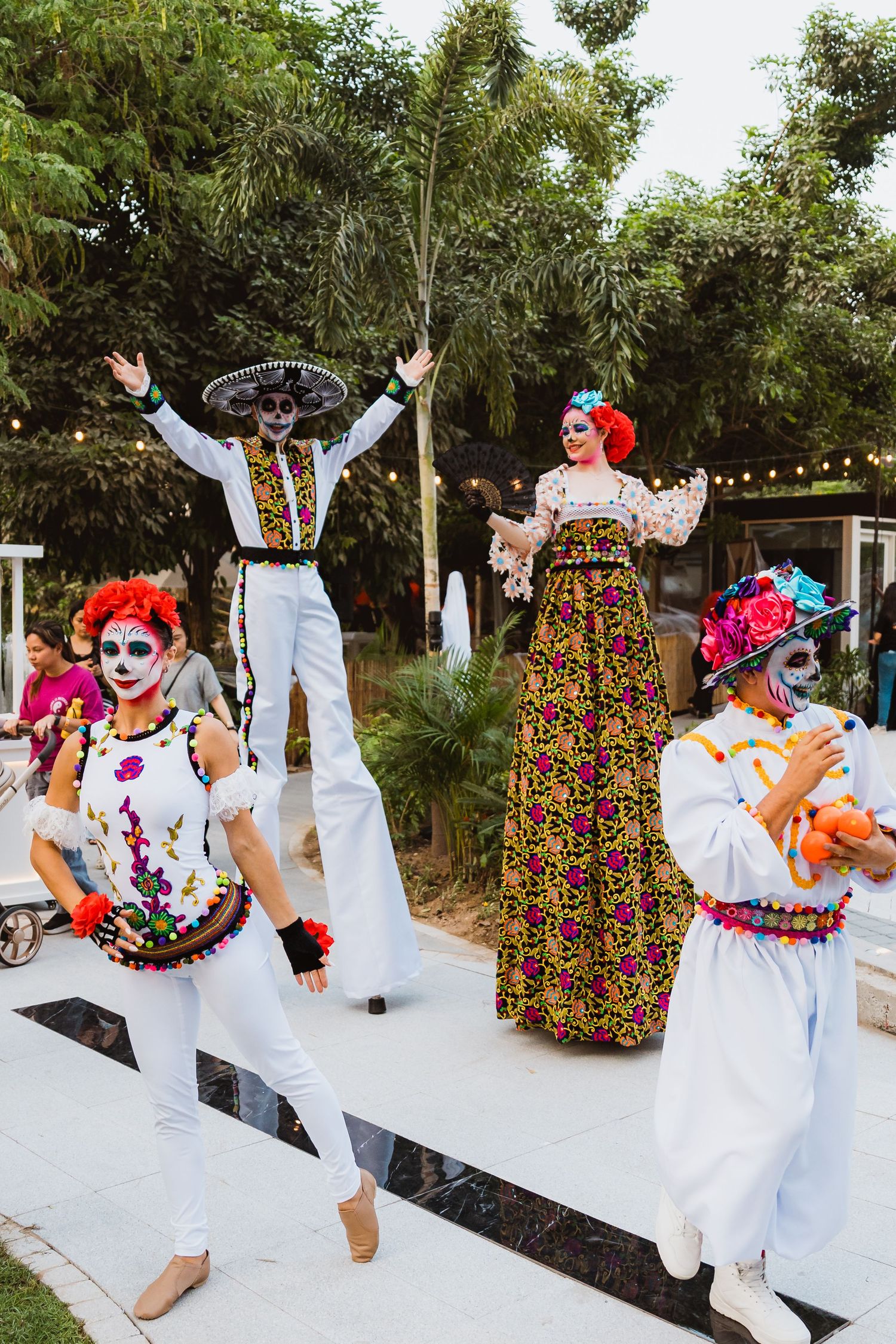 Stilt performers entertaining families during outdoor celebration