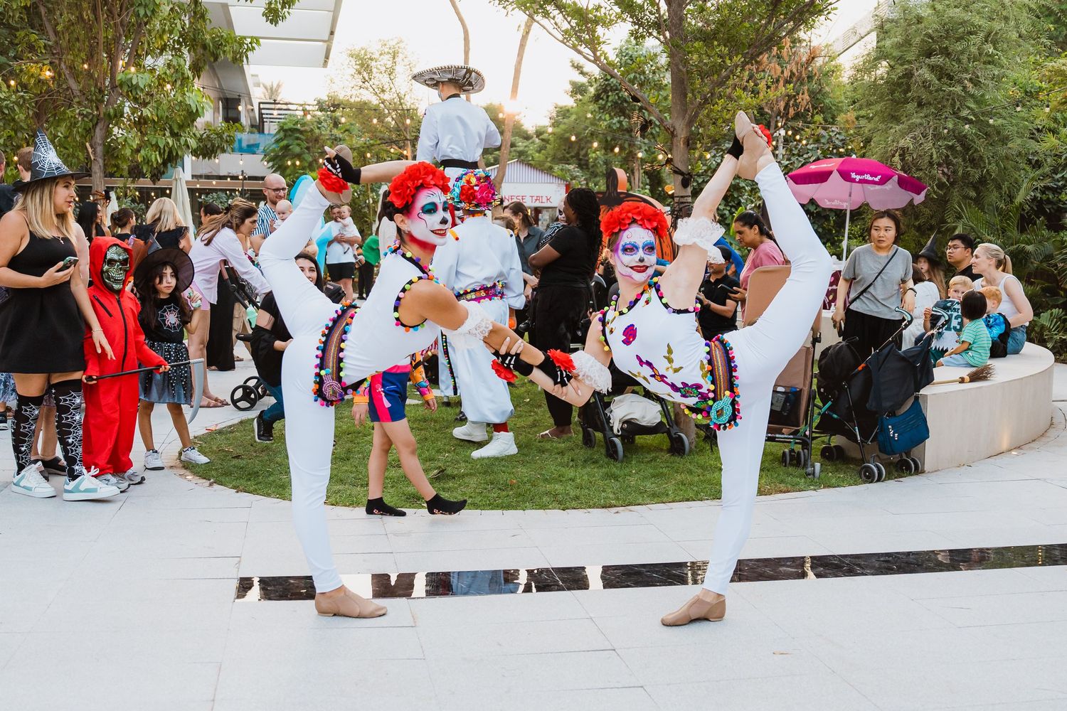 Performers entertaining families at outdoor Halloween festival in Dubai