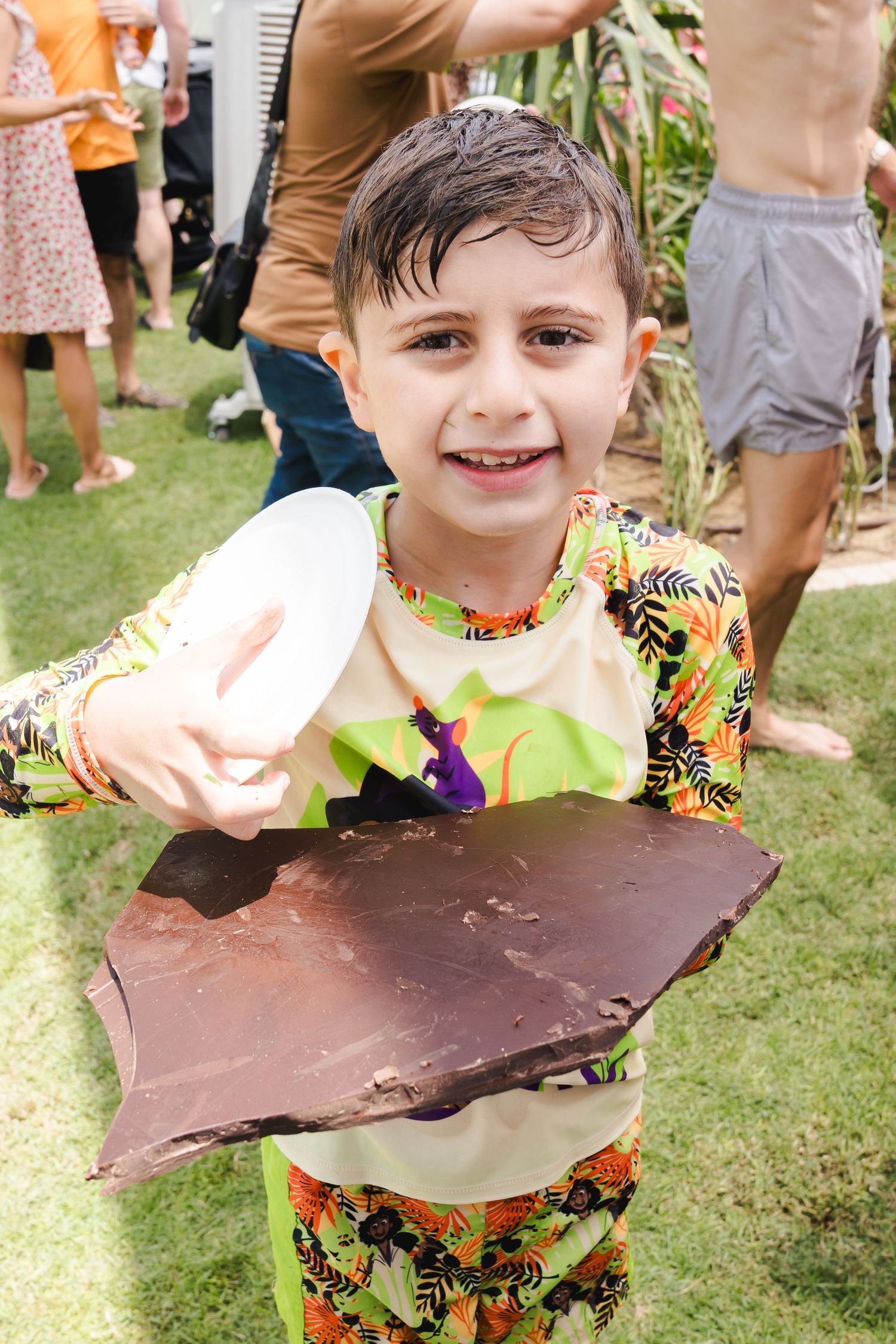 Child holding a piece of chocolate at a community event in Dubai
