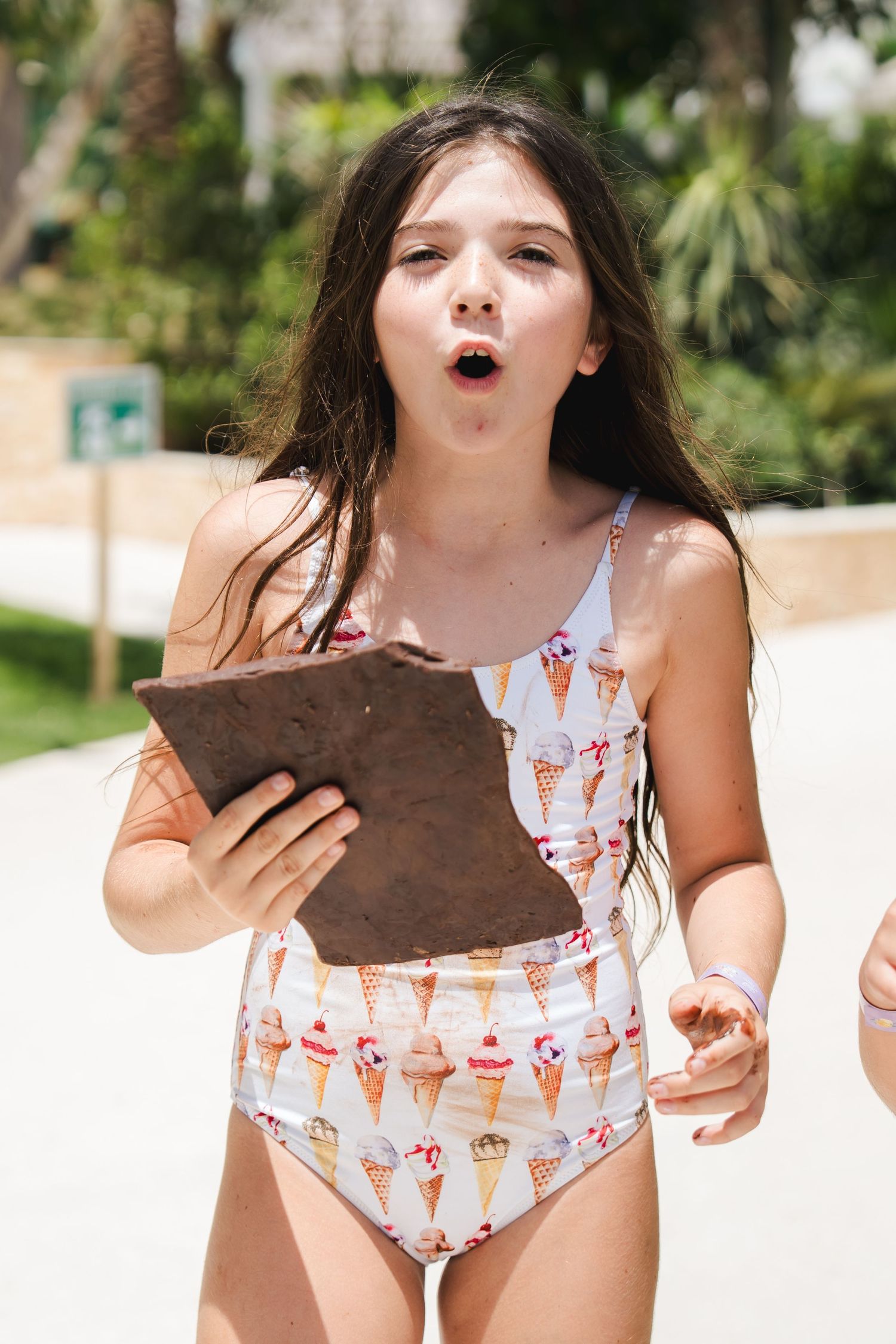 Child reacting during interactive entertainment at a poolside event in Dubai