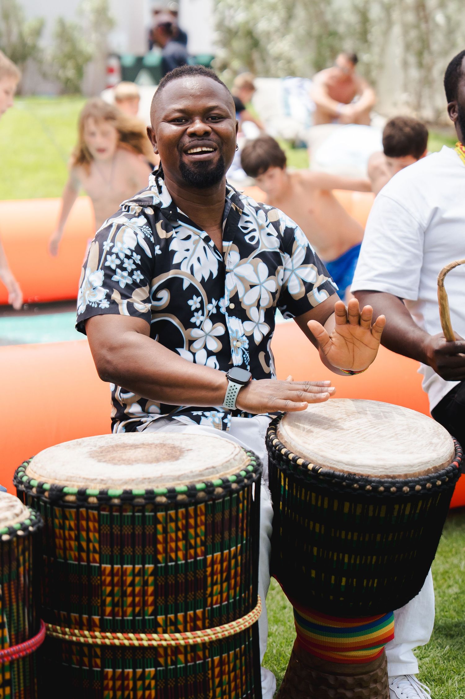 Percussion performer playing drums at an outdoor family event in Dubai