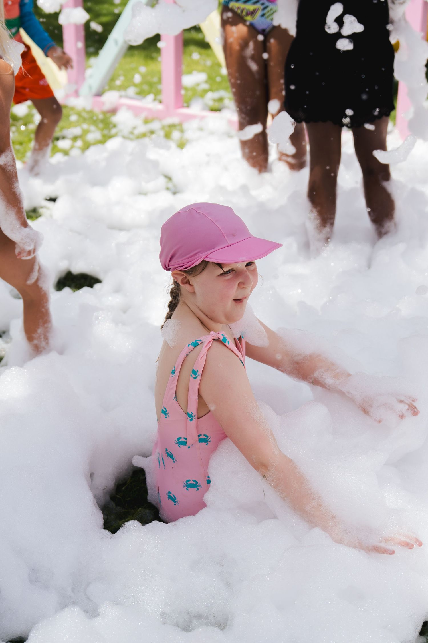 Child enjoying foam party fun at an outdoor community event in Dubai