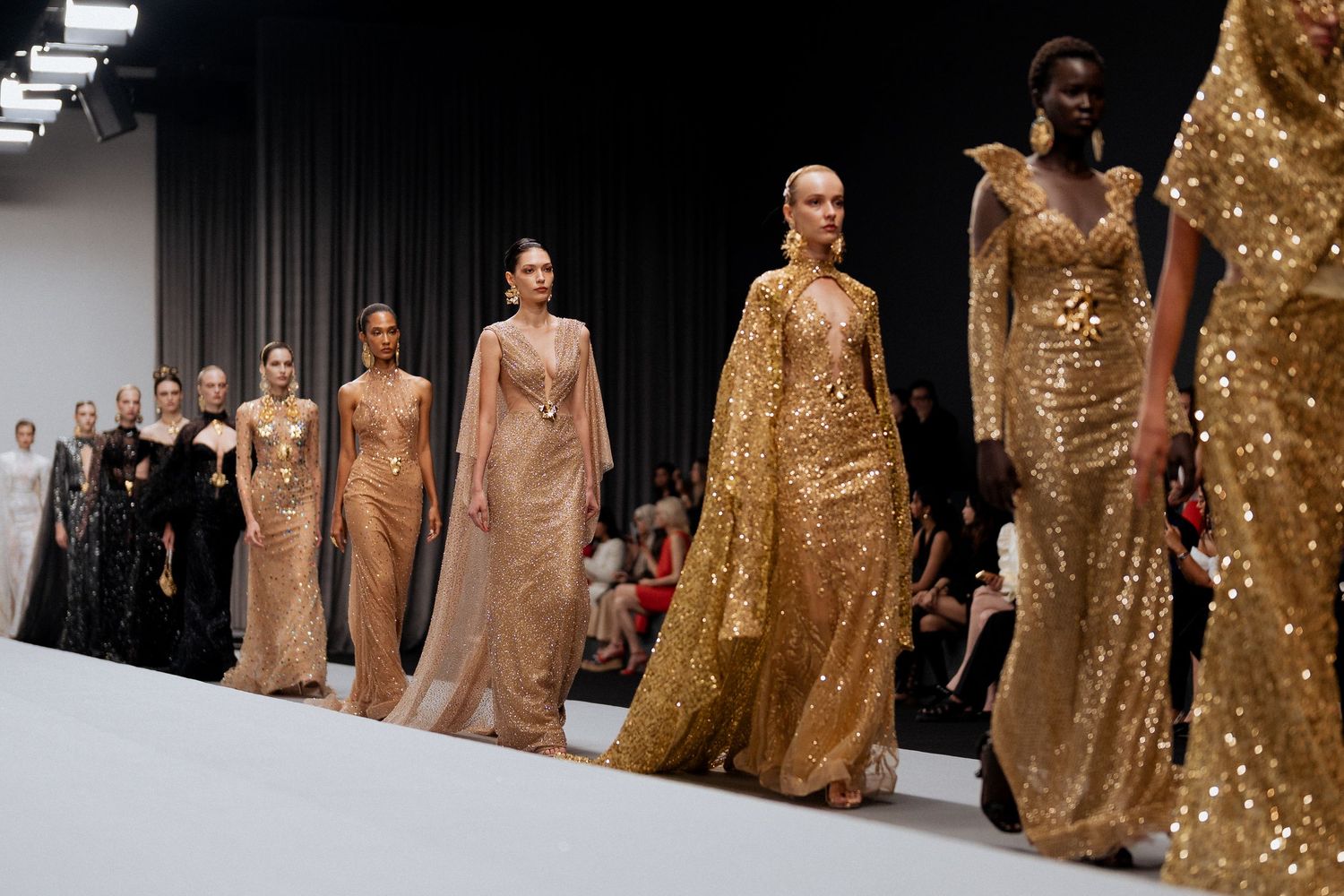 Runway presentation featuring elegant evening dresses at fashion event in Dubai