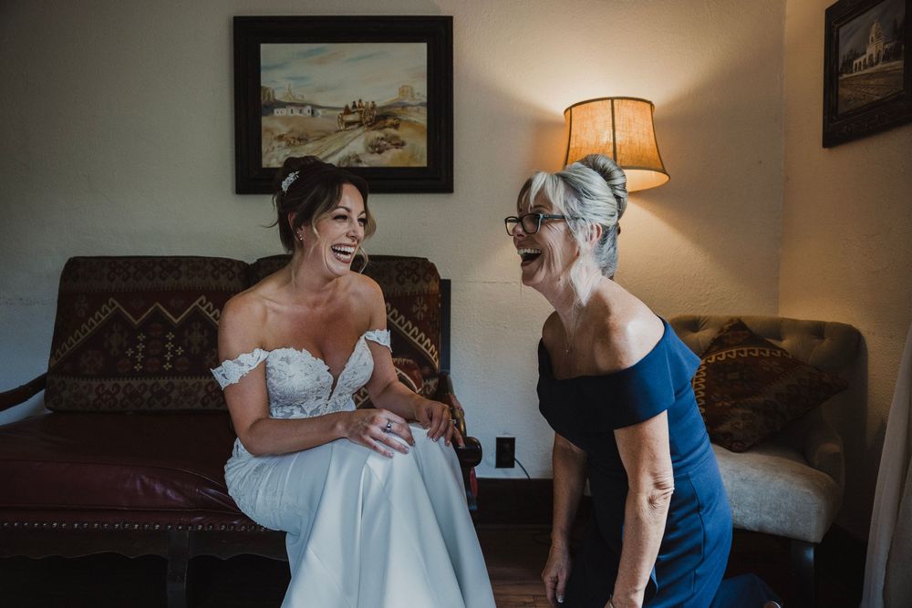 A series of intimate getting ready moments showing a bride in a white dress being helped with final preparations.