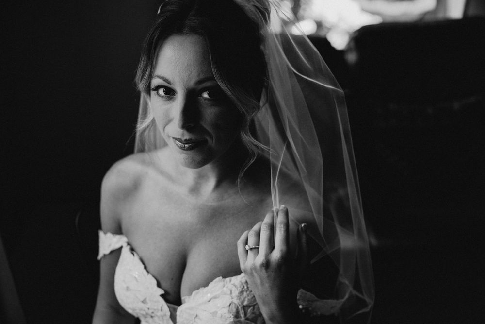 Artistic black and white portraits capture candid bridal moments in natural light.