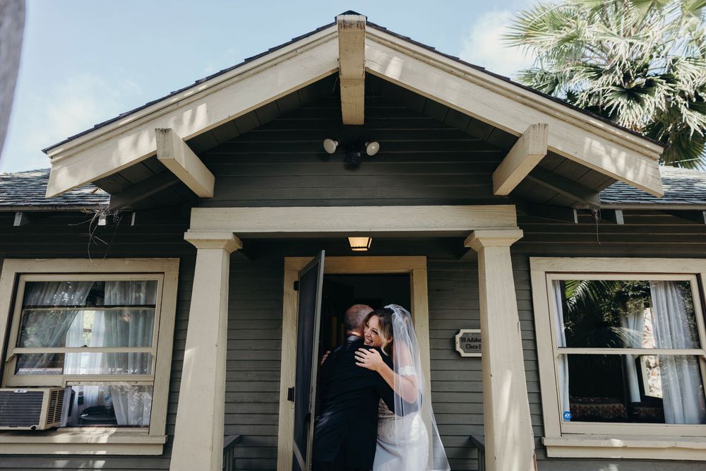 A craftsman-style house exterior serves as a wedding day venue backdrop.