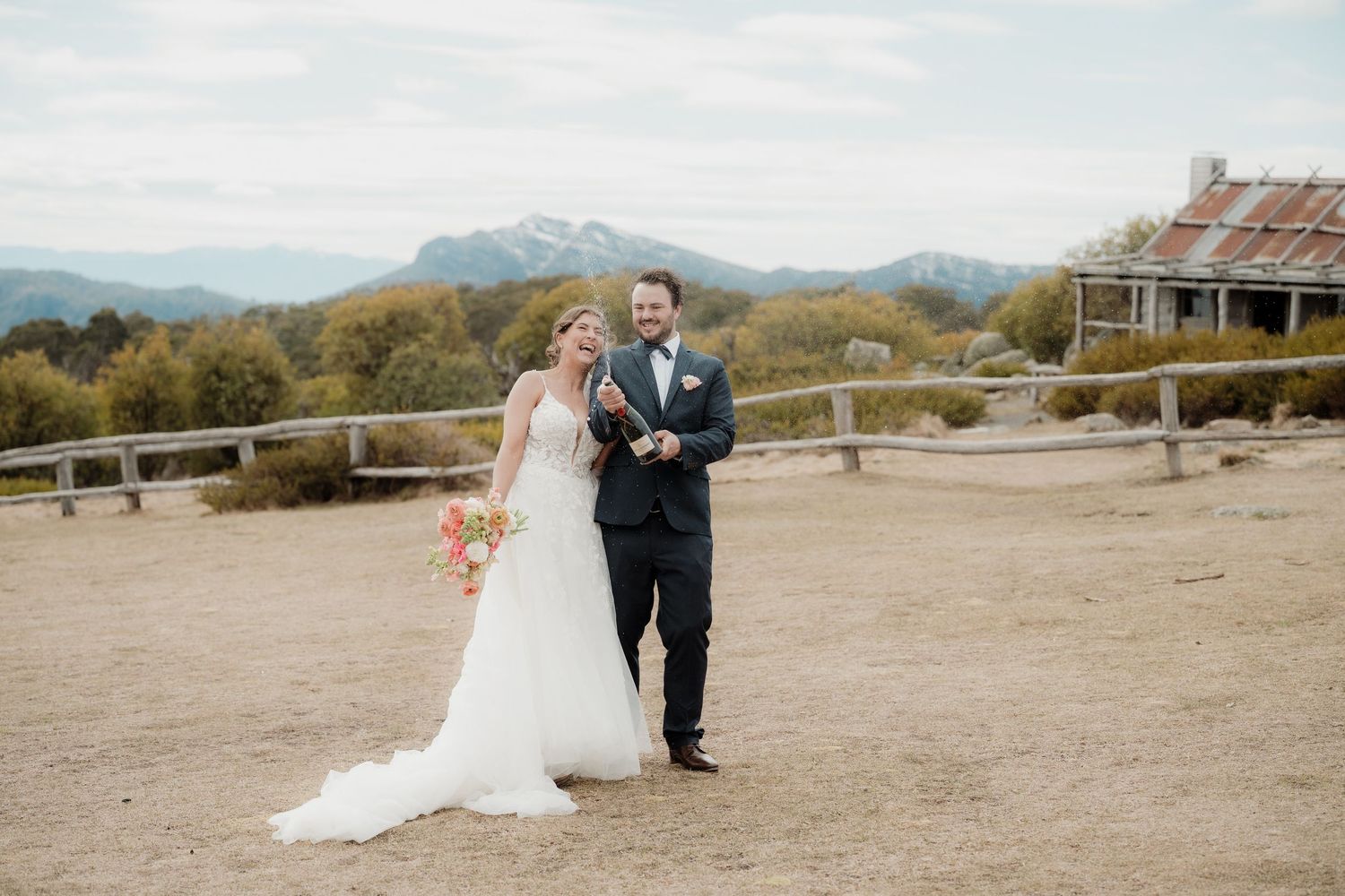 A couple popping champagne after getting married at Craigs Hut
