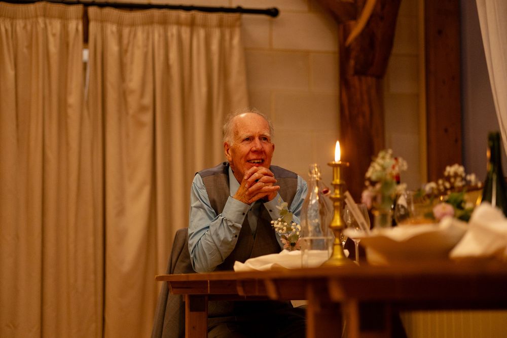 Intimate dinner setting with candlelight and rustic wooden beams creating ambiance.