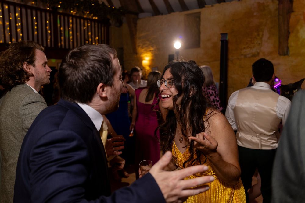 Wedding reception venue decorated with warm lighting and string lights creating a romantic atmosphere.