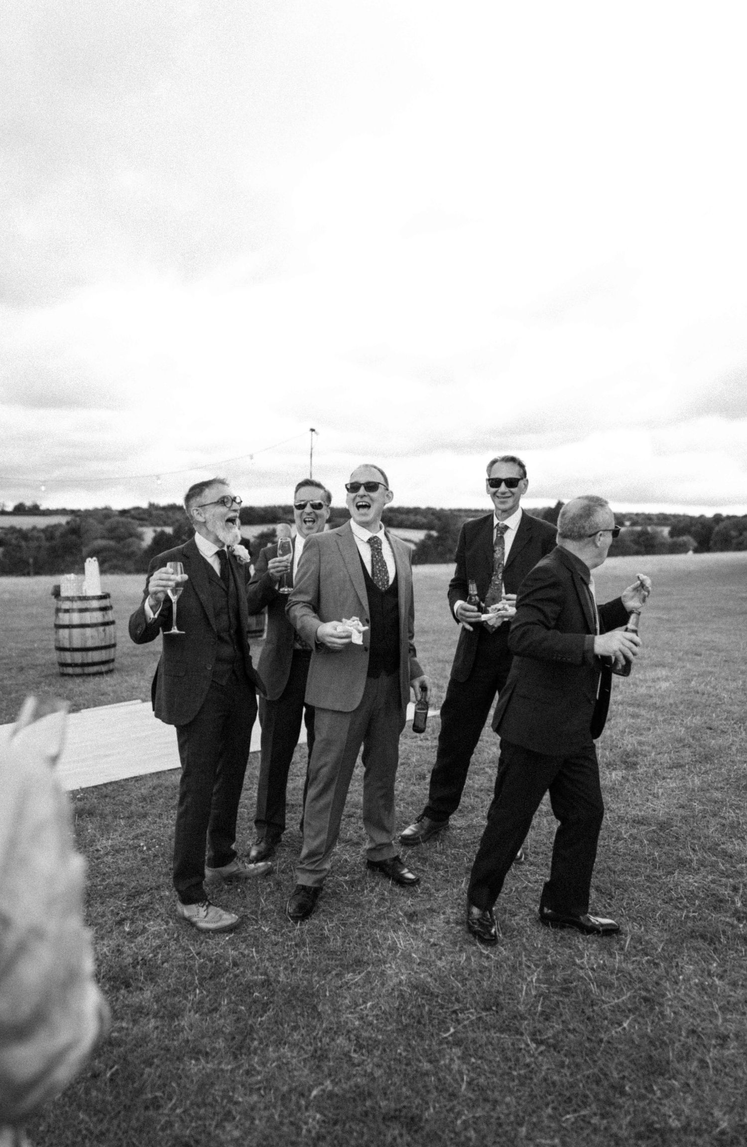 Five men on the field mid laughter