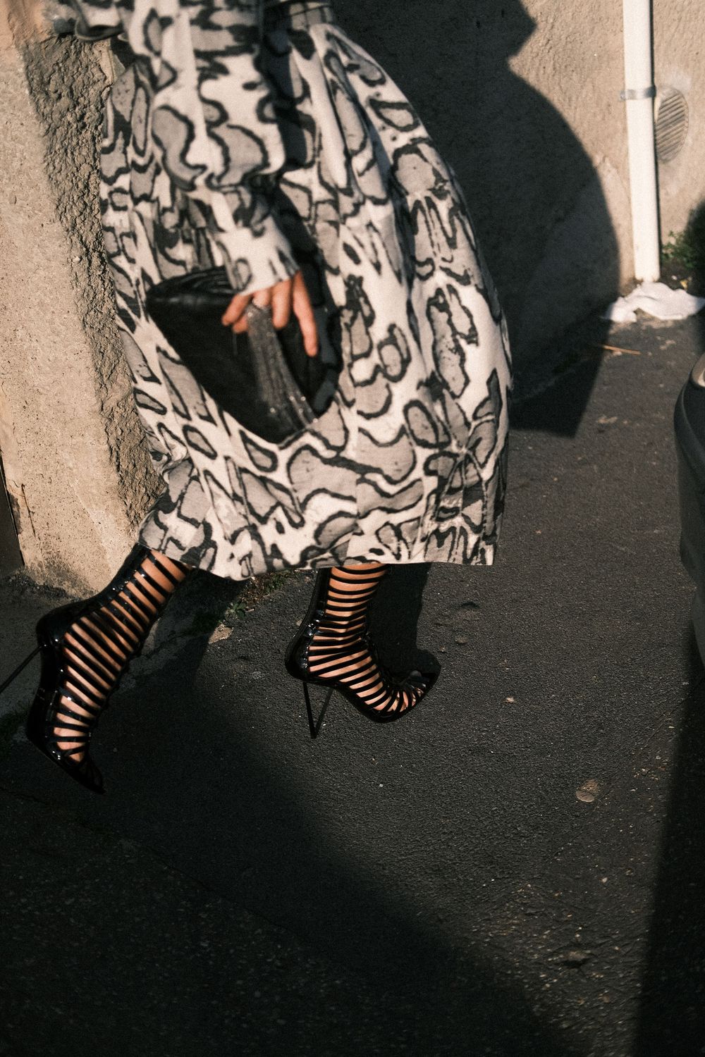 A sequence of black and white photos showing striped stockings and patterned fabric against a dark background.