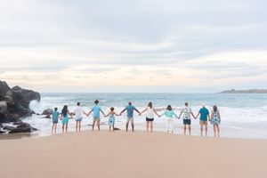 Maui family photographer photo against beautiful Maui beach cliff sunset by ohwowfotos.