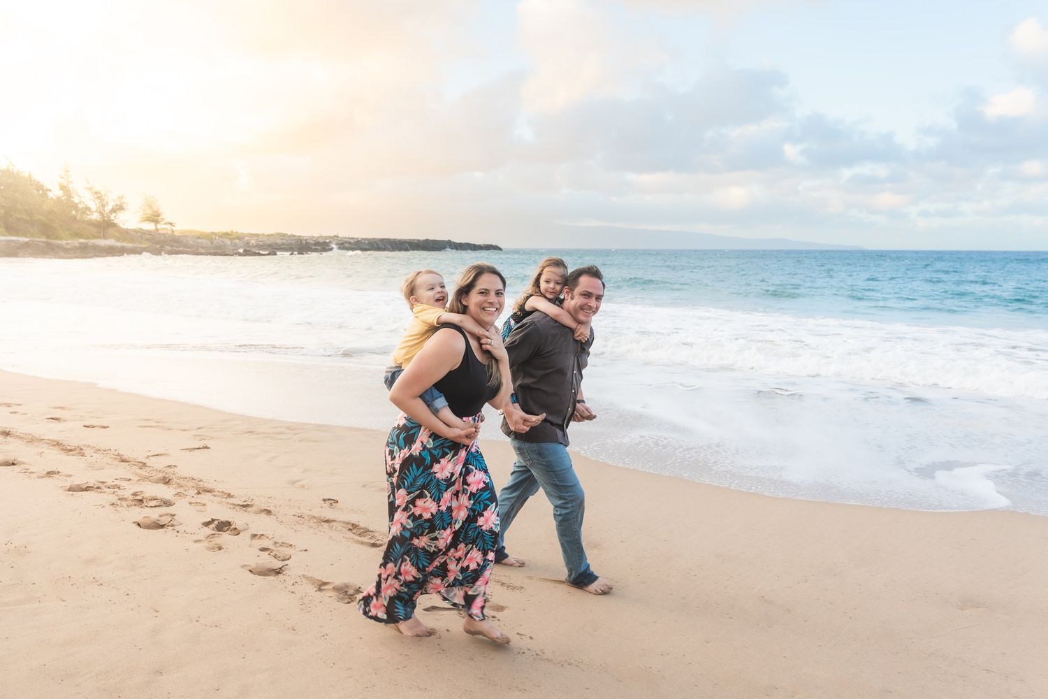 Maui family photographer photo against beautiful Maui beach cliff sunset by ohwowfotos.