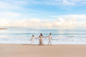 Maui family photographer photo against beautiful Maui beach cliff sunrise by ohwowfotos.