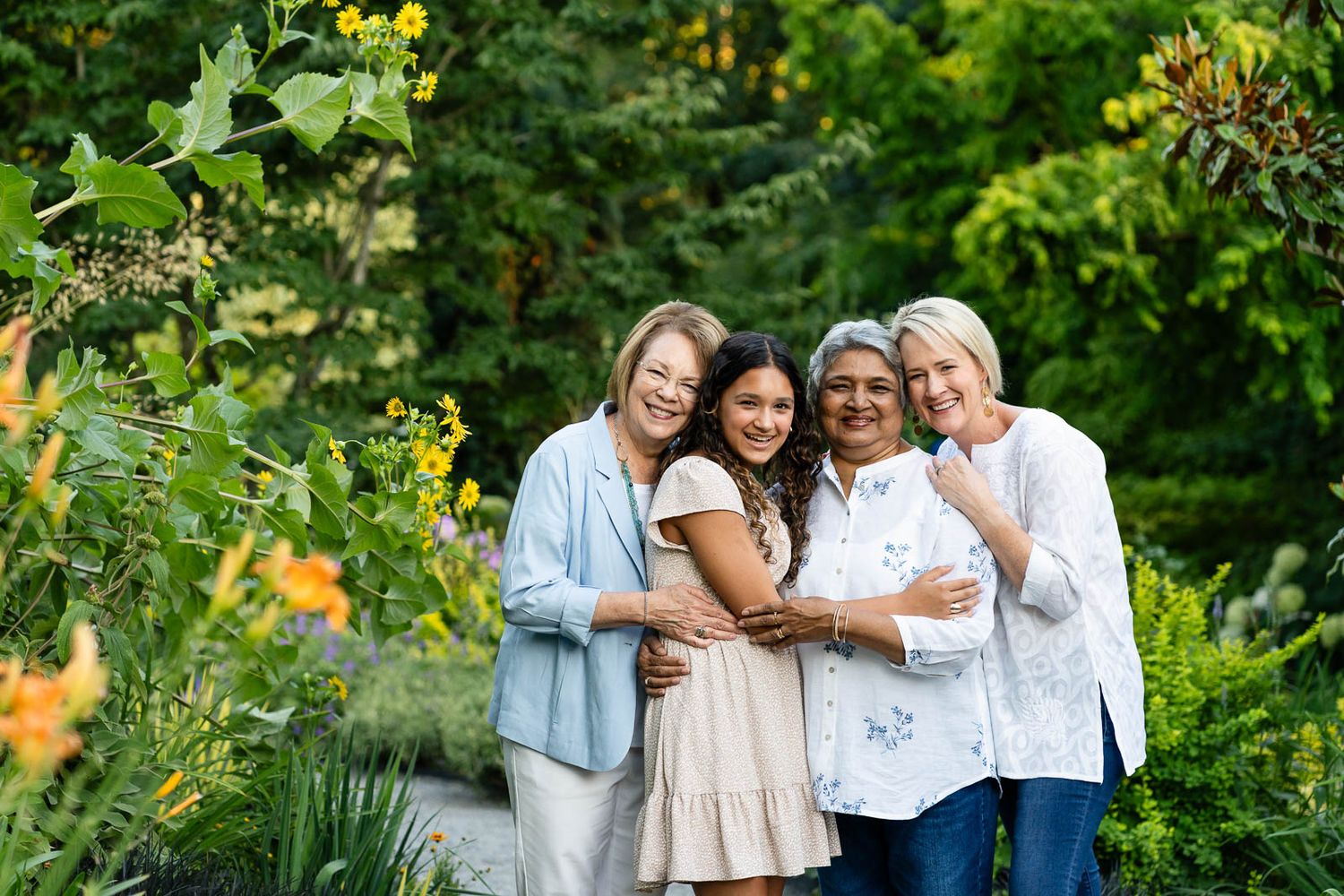 Grandmothers, mother and daughter pose for portrait.