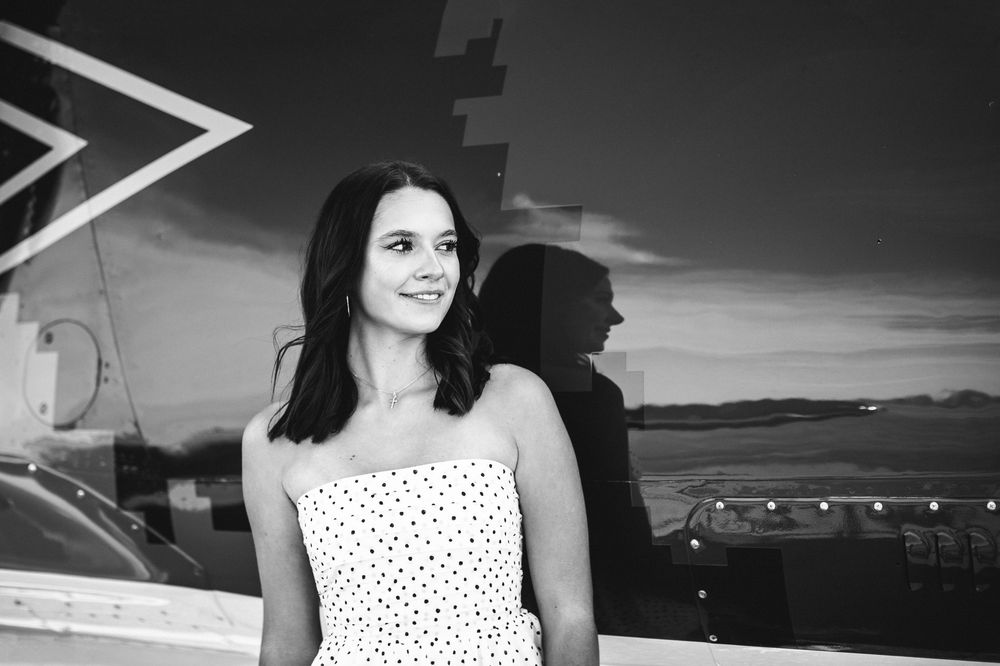 Modern editorial style senior portrait at airport with girl  in Howell Michigan; senior aviation photos by South Lyon, MI photographer