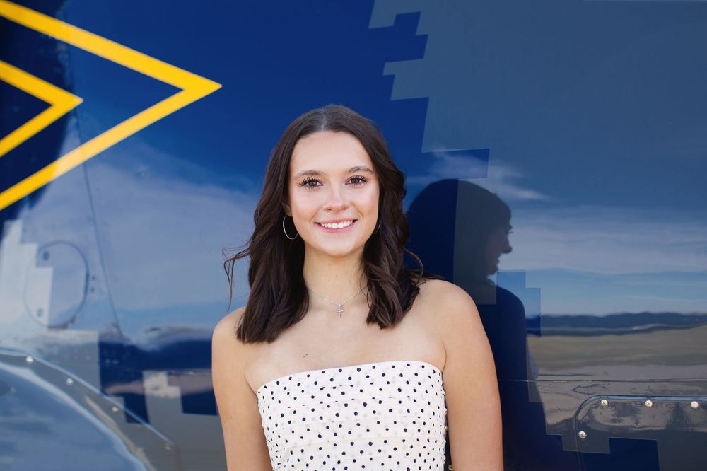 Modern editorial senior portrait with girl and jet plane in Howell Michigan; senior aviation photos by Brighton, MI photographer