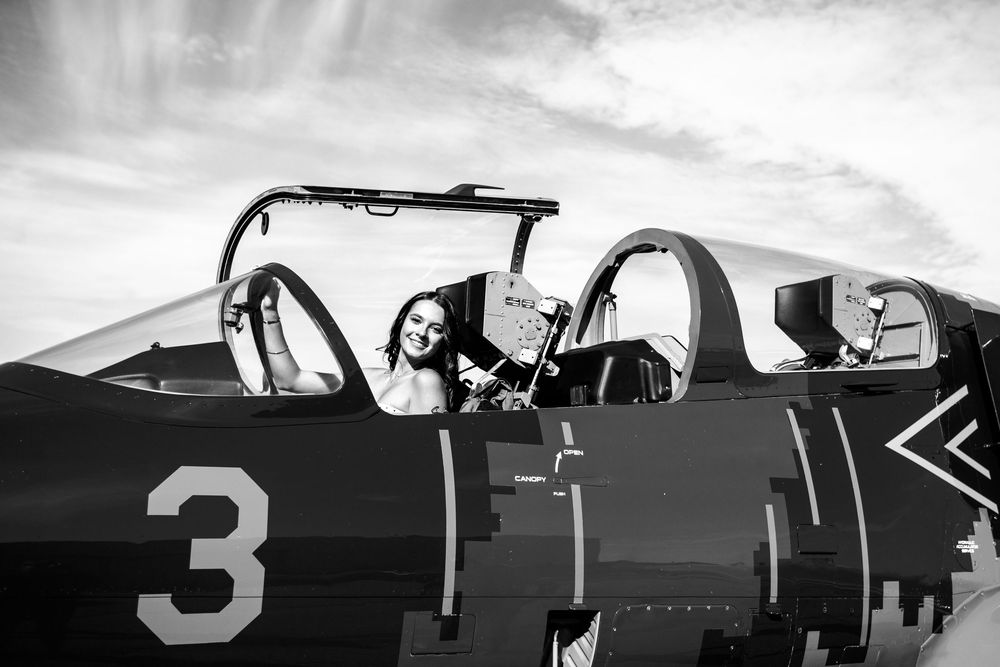 Modern editorial senior portrait with girl in jet plane in Howell Michigan; senior aviation photos by South Lyon, MI photographer
