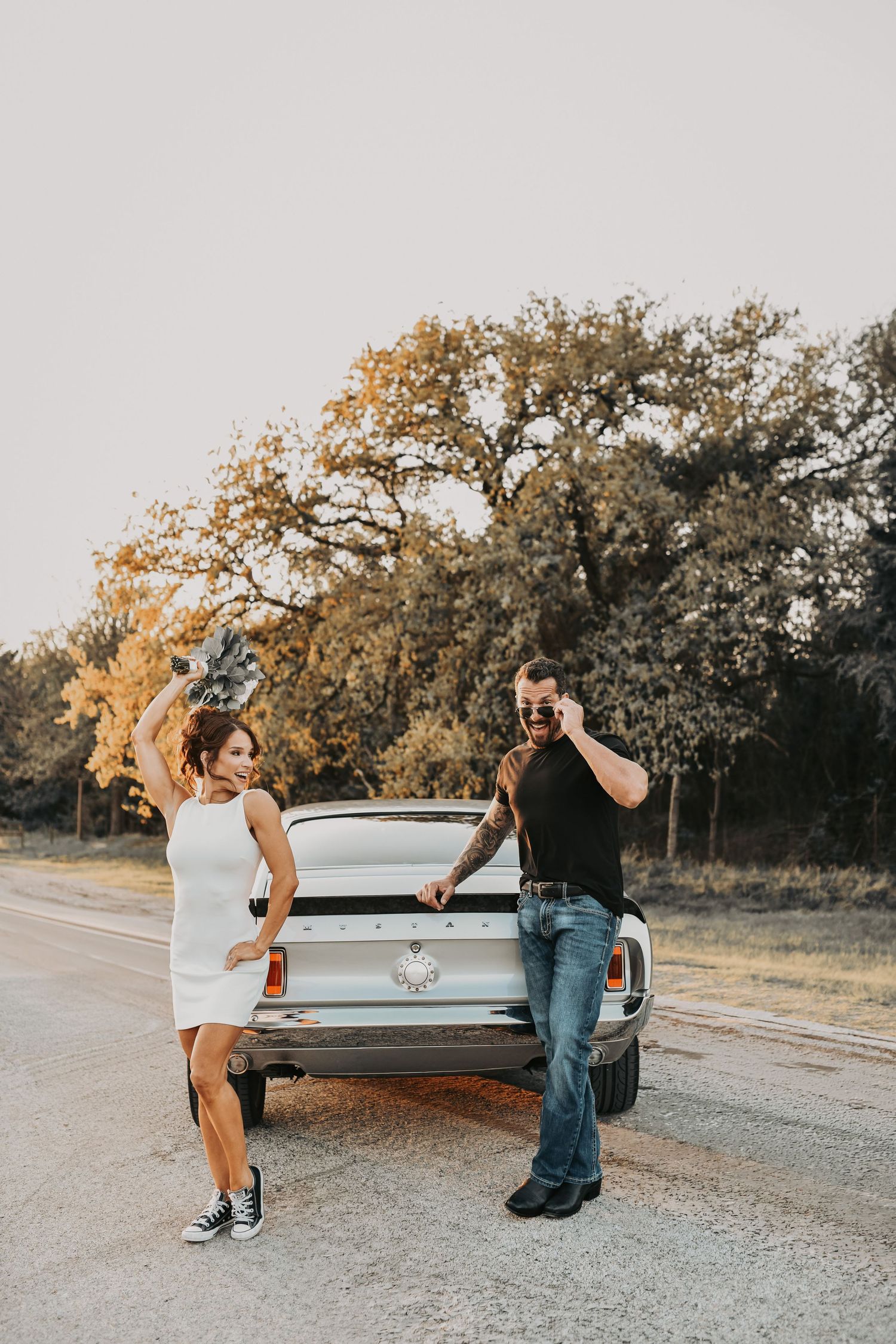 couple posing with 1969 Ford Mustang Mach 1 fastback engagement session