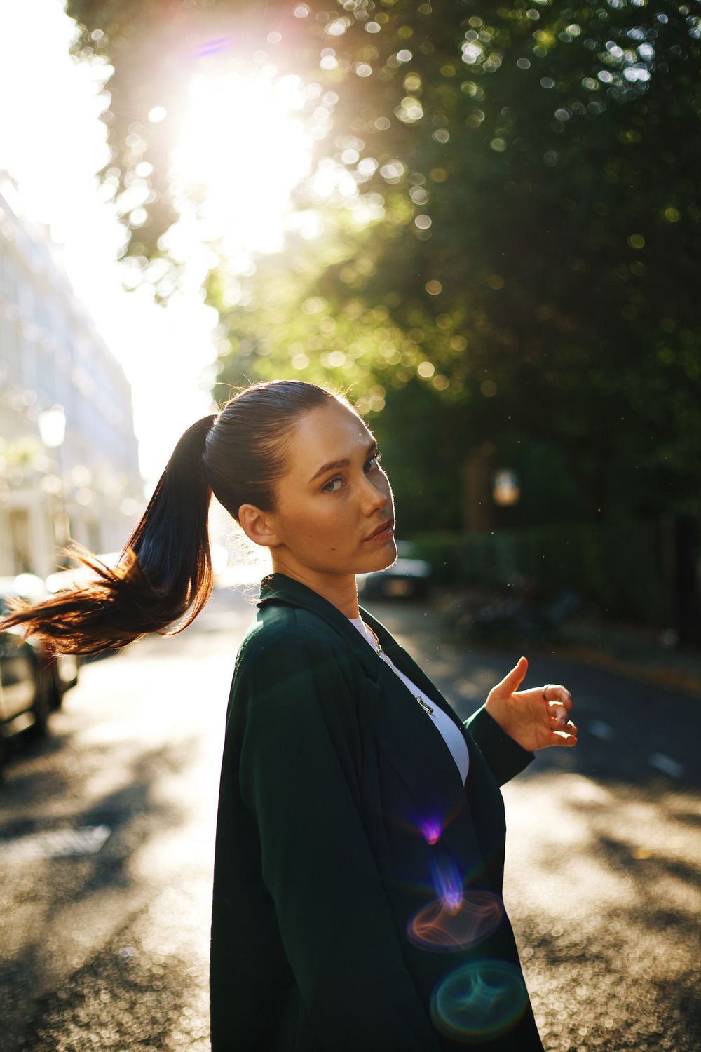 Silhouette portrait in golden sunlight with lens flares and bokeh effects.