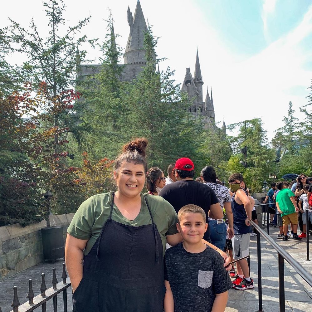 Mom and son at Universal Studios Florida in front of Hogwarts during family trip