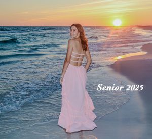 A figure in a flowing pink dress poses on a beach at sunset with waves breaking on the shore and "Senior 2025" text overlay.