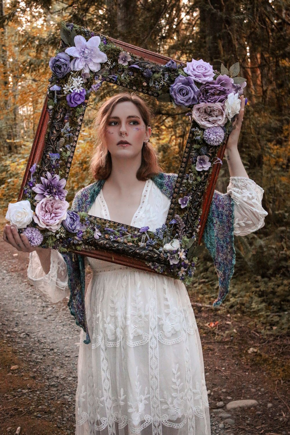 Ethereal woodland photo series featuring antique frame adorned with purple and pink flowers against a dreamy autumn forest backdrop.