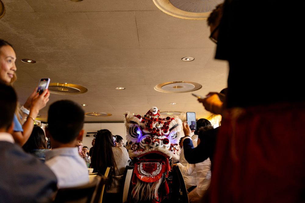 Party guests holding up phones to capture moments at a lively indoor celebration.