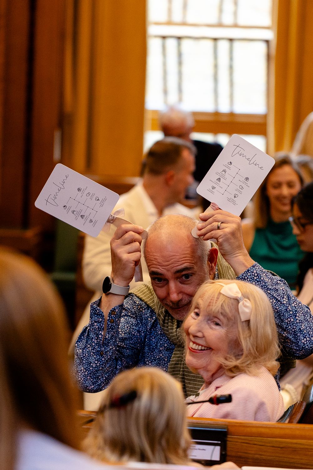 Wedding guests participate joyfully in a fun quiz game during the reception celebration.