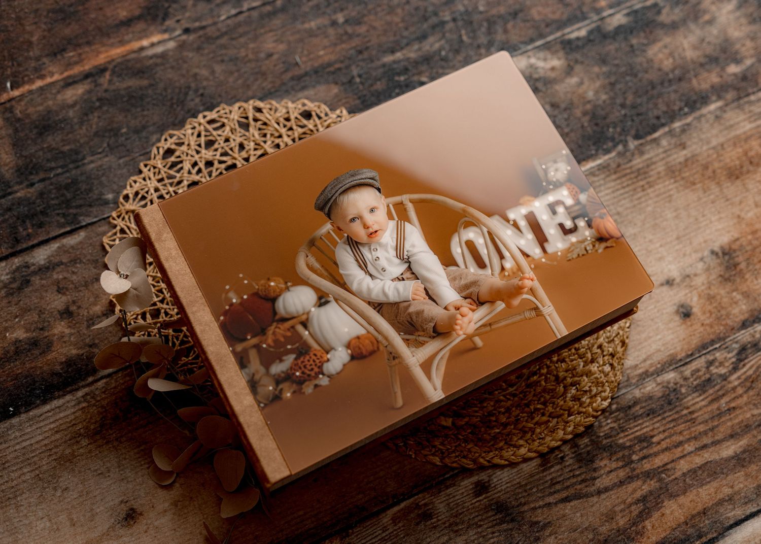 Sepia-toned photo display on decorative gold mesh surface with wooden background.