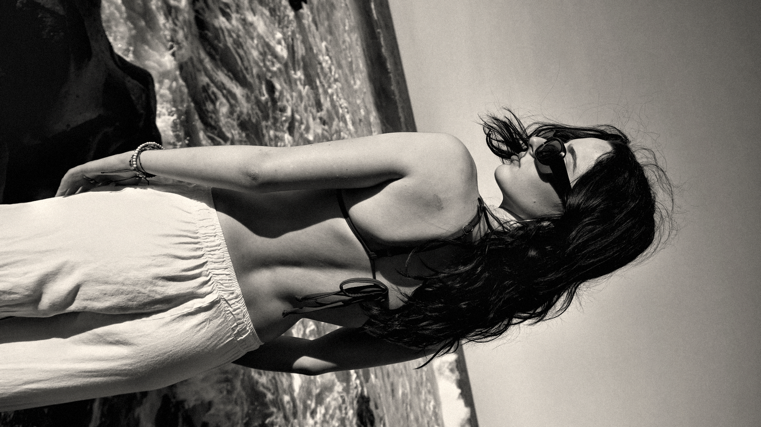 Black and white artistic fashion portrait with simple styling.