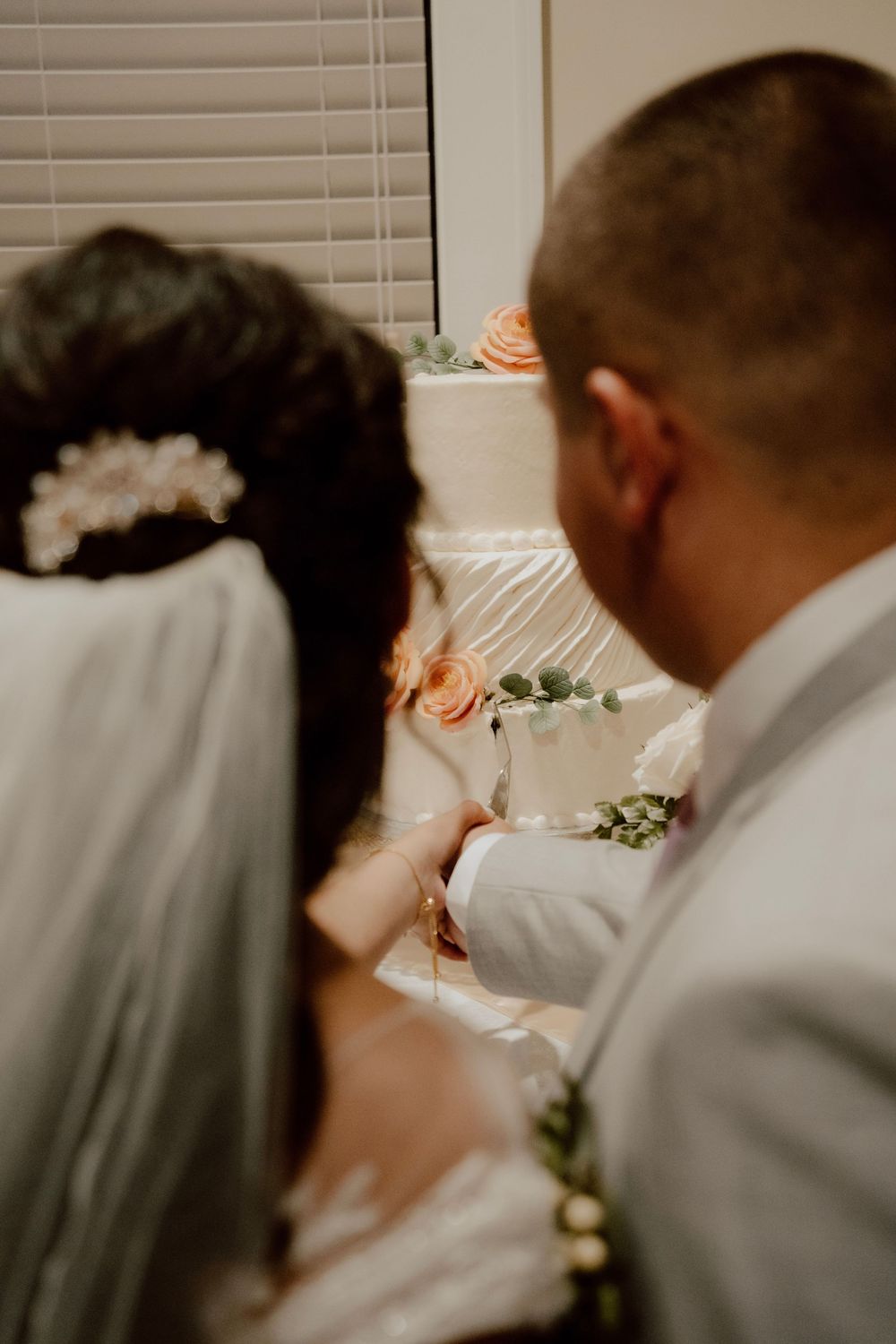 Close-up view of newlyweds from behind during an intimate wedding moment.